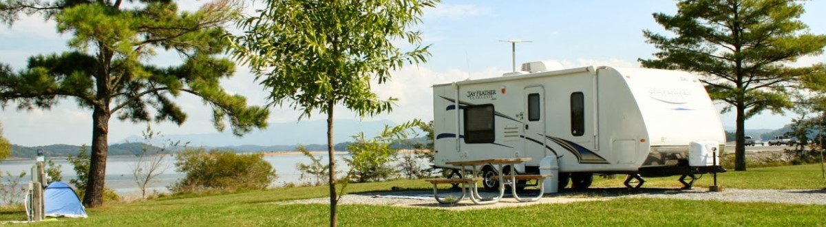 Jayco Jay Feather camping back of a lake. Of Valley RV Supercenter at 619 Washington Ave N